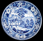 Pearlware Canova shape handled cup printed underglaze in medium blue. One of two matching cups from this assemblage. 3.5” rim diameter; 2.25” vessel height. Middle image is cup interior. Image on right, a plate, whose pattern is called "The Footbride," is from a private collection.